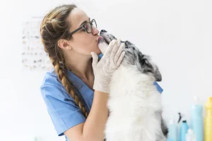 dog-licking-female-veterinarian-s-mouth-clinic dog-licking-female-veterinarian-s-mouth-clinic